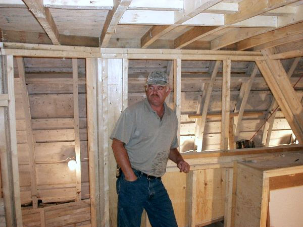 669: Bernard Mulrooney's new boat under construction in Placentia. This picture includes  the builder himself. (2004)